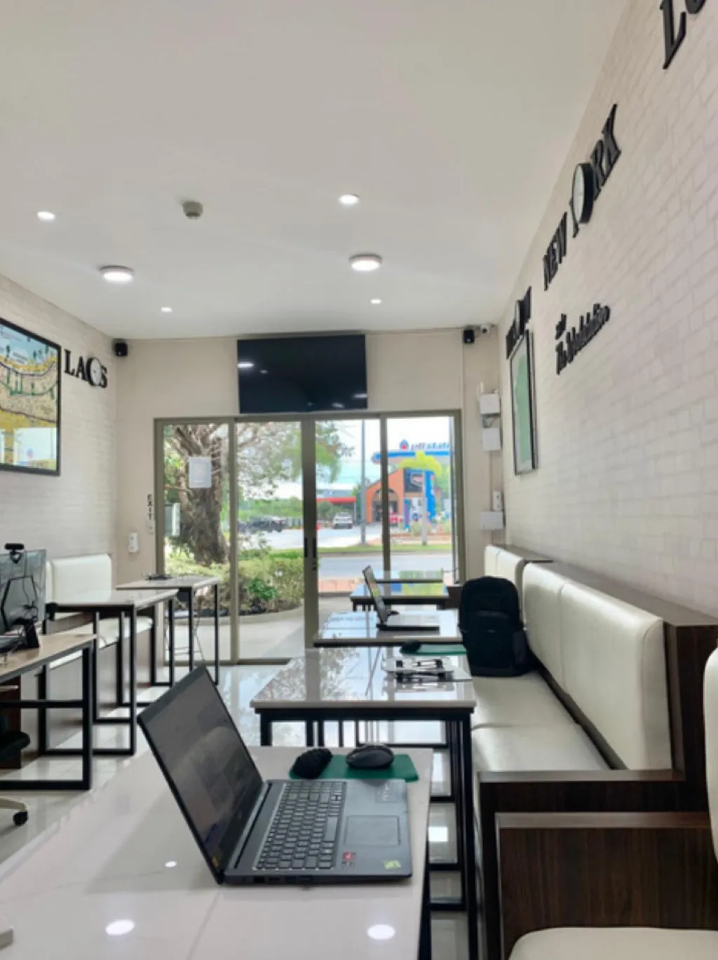 Lounge banquettes and work tables by the front windows